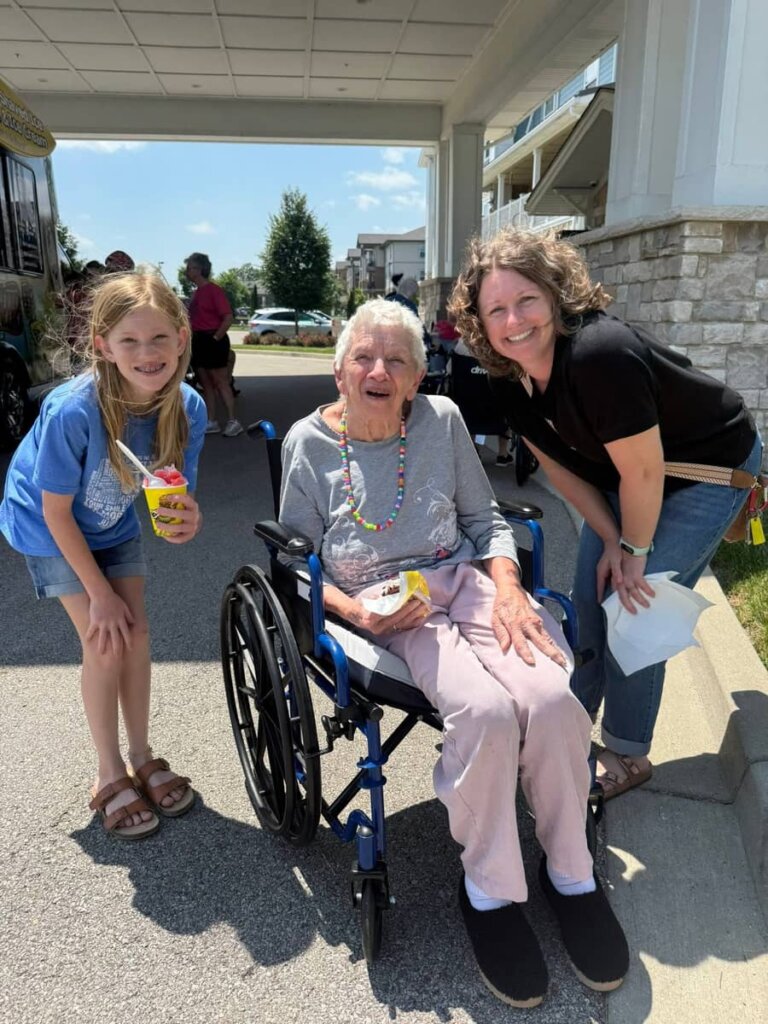 A resident enjoys shaved ice while spending time with family during an outdoor community event at Traditions of Columbus.