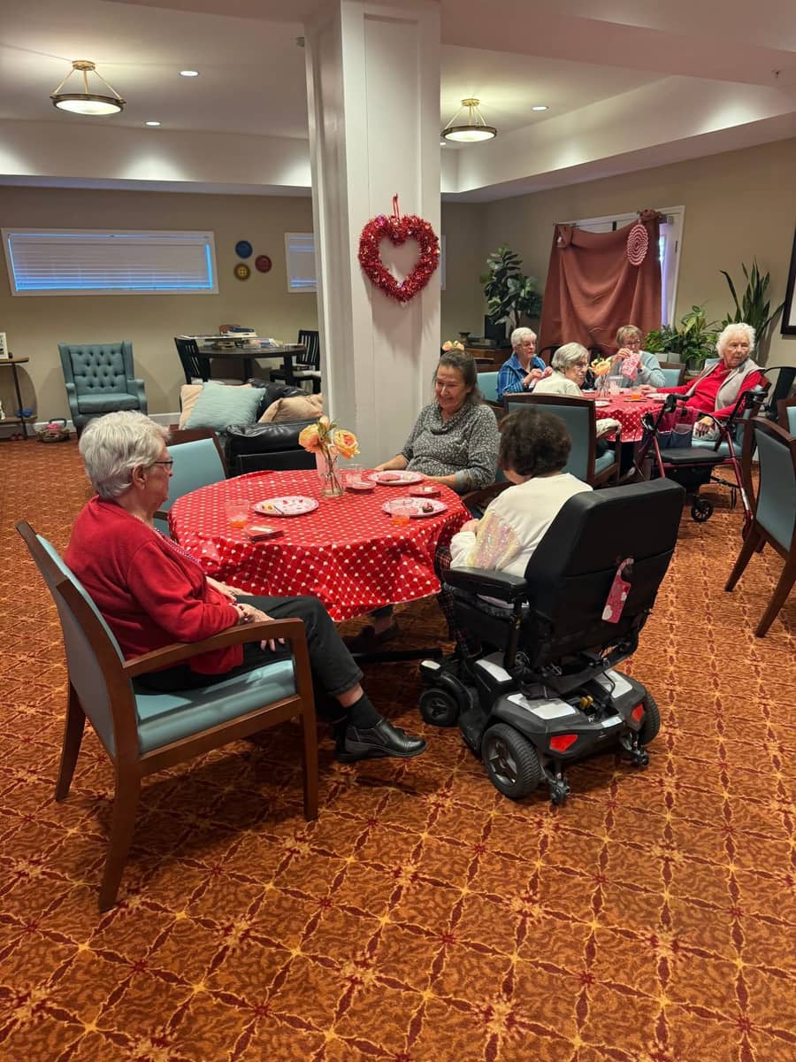 Residents gather for a Valentine’s Day celebration featuring festive décor, desserts, and time with friends.