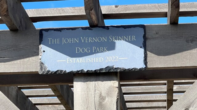 A close-up of the John Vernon Skinner Dog Park sign